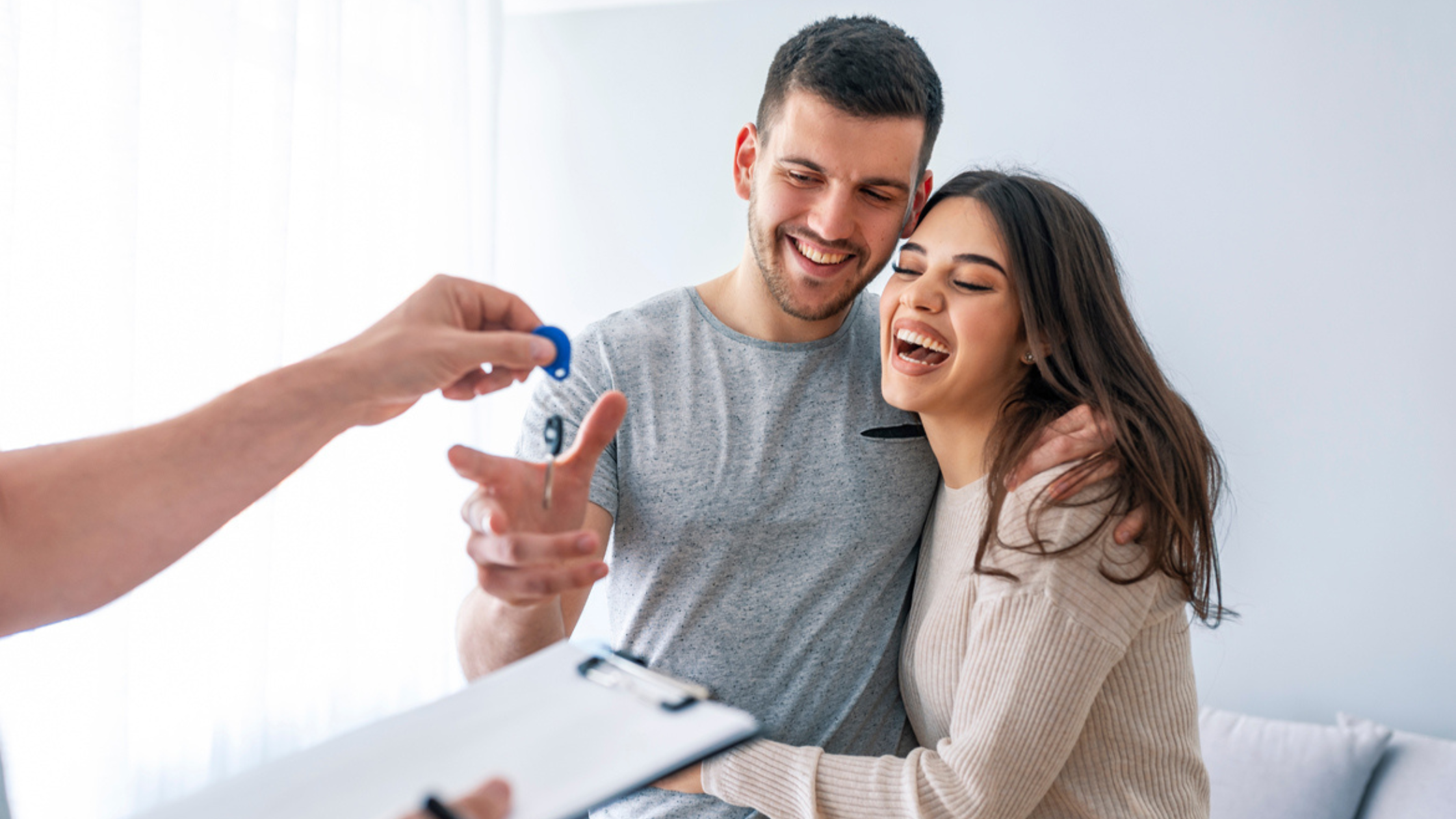 Young couple getting keys to new home