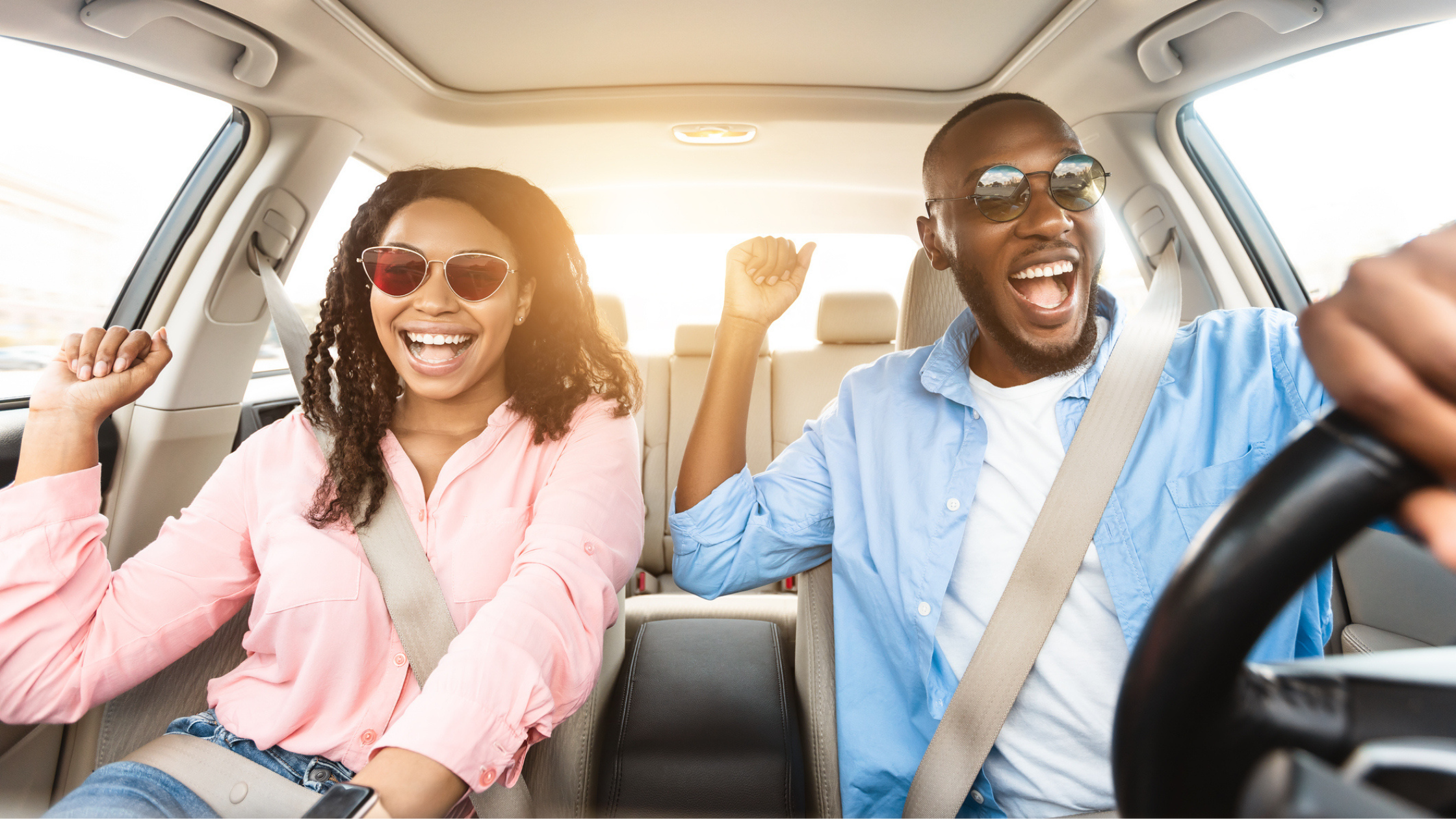 Happy couple riding in a car